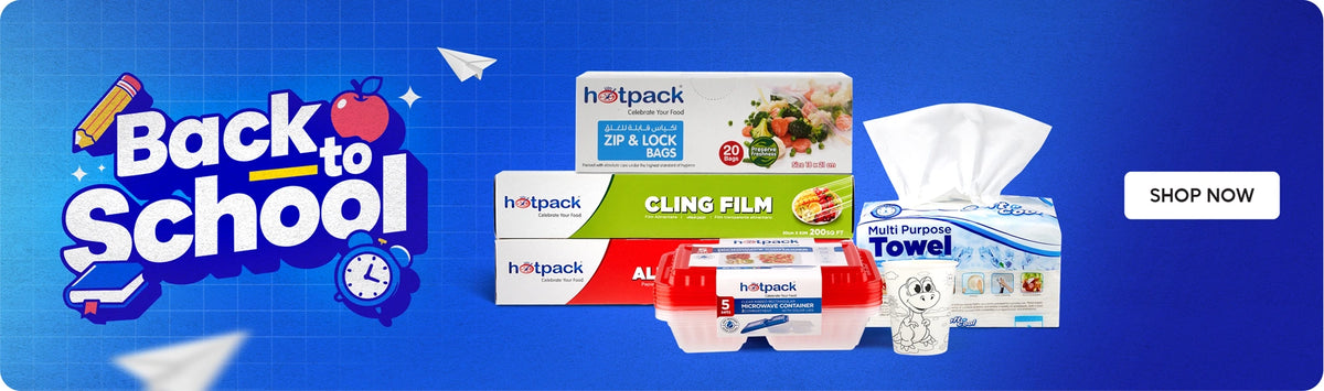 Back to School banner featuring Hotpack zip & lock bags, cling film, aluminum foil, biodegradable containers and multi-purpose towels with school-themed graphics including pencil, apple, clock and paper plane icons on a blue gradient background with Shop Now call to action. بانر العودة إلى المدرسة يعرض أكياس زيب آند لوك من هوت باك، غلاف بلاستيكي، ورق ألمنيوم، حاويات قابلة للتحلل ومناديل متعددة الاستخدامات مع رسومات مدرسية تشمل قلم رصاص، تفاحة، ساعة وطائرات ورقية على خلفية زرقاء متدرجة مع زر تسوق الآن.