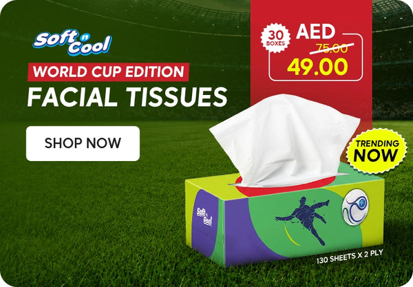 Soft & Cool World Cup Edition Facial Tissues banner featuring a green and purple World Cup Edition tissue box with footballer and ball design, 130 sheets x 2 ply, priced at AED 49.00 down from AED 75.00 for 30 boxes with Trending Now badge displayed on a football stadium grass background with Shop Now call to action. | بانر مناديل ورقية للوجه إصدار كأس العالم سوفت آند كول يعرض علبة مناديل خضراء وبنفسجية بتصميم كأس العالم مع لاعب كرة قدم وكرة، 130 منديل × طبقتين، بسعر 49.00 درهم بدلاً من 75.00 درهم لـ 30 صندوق مع شارة الأكثر رواجاً الآن معروضة على خلفية ملعب كرة قدم مع زر تسوق الآن.