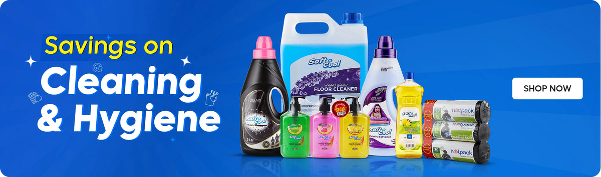 Eid Essentials banner featuring Hotpack premium disposable tableware and party supplies including decorative facial tissue boxes, foil containers, ornate serving trays, and festive packaging displayed on elegant purple geometric podiums with hanging lanterns and stars on a gradient purple background with crescent moon motif and Shop Now call to action. بانر مستلزمات العيد يعرض منتجات هوت باك المميزة من أدوات المائدة ومستلزمات الحفلات التي تستخدم لمرة واحدة بما في ذلك علب مناديل مزخرفة، علب فويل، صواني تقديم فاخرة وتغليف احتفالي معروضة على منصات هندسية بنفسجية أنيقة مع فوانيس معلقة ونجوم على خلفية بنفسجية متدرجة مع زخرفة الهلال وزر تسوق الآن.