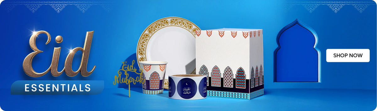 Eid Essentials banner – blue Ramadan-themed design featuring the text “Eid Essentials” and a Shop Now button, displaying festive disposable tableware including patterned paper cups, decorative plates, Eid-themed stickers/labels, and a Ramadan-style food packaging box with Islamic geometric window patterns. The products are arranged on a podium with an Eid Mubarak decoration and a mosque arch motif in the background, representing Hotpack disposable tableware and packaging for Eid celebrations, gatherings, and food service. لافتة مستلزمات العيد – تصميم أزرق بطابع رمضاني يعرض عبارة "Eid Essentials" مع زر "Shop Now"، ويظهر مجموعة من مستلزمات المائدة للاحتفالات تشمل أكواب ورقية مزخرفة، أطباق بتصاميم احتفالية، ملصقات بعبارة عيد مبارك، وصندوق تغليف طعام بنقوش هندسية إسلامية. المنتجات موضوعة على منصة مع زينة "Eid Mubarak" وخلفية على شكل قوس مسجد، وتمثل منتجات هوتباك من أدوات المائدة والتغليف للاحتفالات والتجمعات خلال عيد الفطر.
