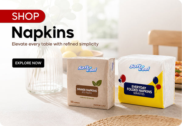 Shop Napkins banner featuring Soft & Cool Dinner Napkins Eco Touch and Everyday Folded Napkins Serviettes displayed on a dining table setting with Elevate every table with refined simplicity tagline and Explore Now call to action. | بانر تسوق المناديل يعرض مناديل سوفت آند كول دينر نابكينز إيكو تاتش ومناديل مطوية يومية سيرفيتس معروضة على طاولة طعام مع شعار أضف لمسة راقية وبسيطة إلى كل مائدة وزر تصفح الآن.